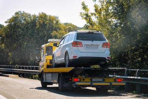Emergency roadside assistance towing an SUV.