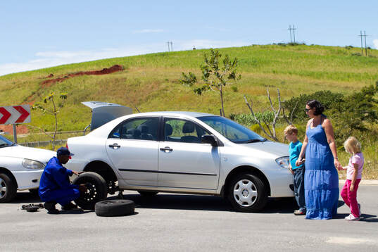 Roadside assistance doing flat tire change